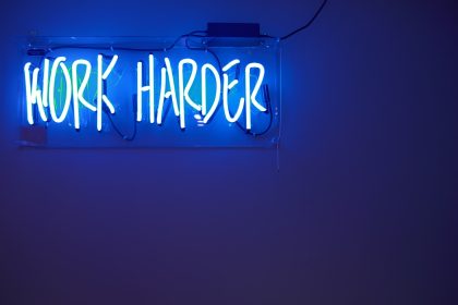 blue Work Harder neon signage