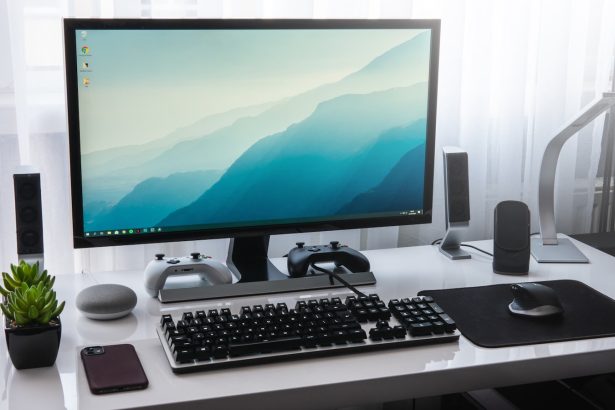 black computer keyboard beside silver imac